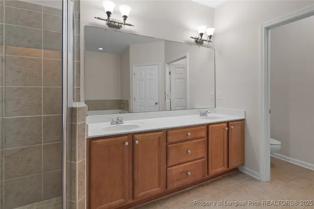 a bathroom with a double vanity sink and mirror