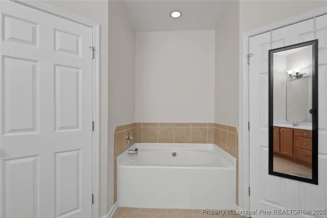 a bathroom with a bathtub and shower