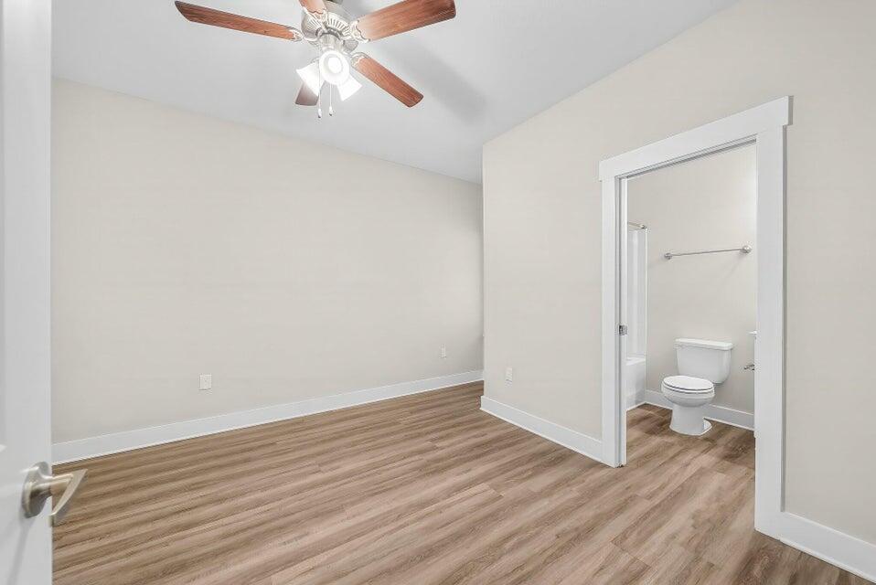 131 North Sand Palm Road, Unit VISTA Freeport, FL 32439 - Photo 17 of 27 a view of a room with wooden floor and ceiling fan