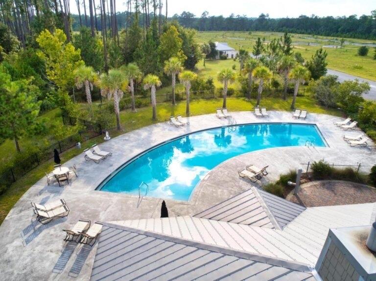 131 North Sand Palm Road, Unit VISTA Freeport, FL 32439 - Photo 22 of 27 a view of a swimming pool with an outdoor seating area