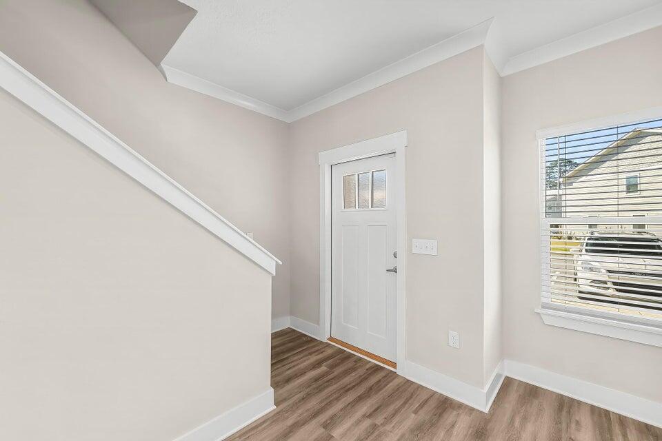 131 North Sand Palm Road, Unit VISTA Freeport, FL 32439 - Photo 9 of 27 a view of a hallway with wooden floor and staircase