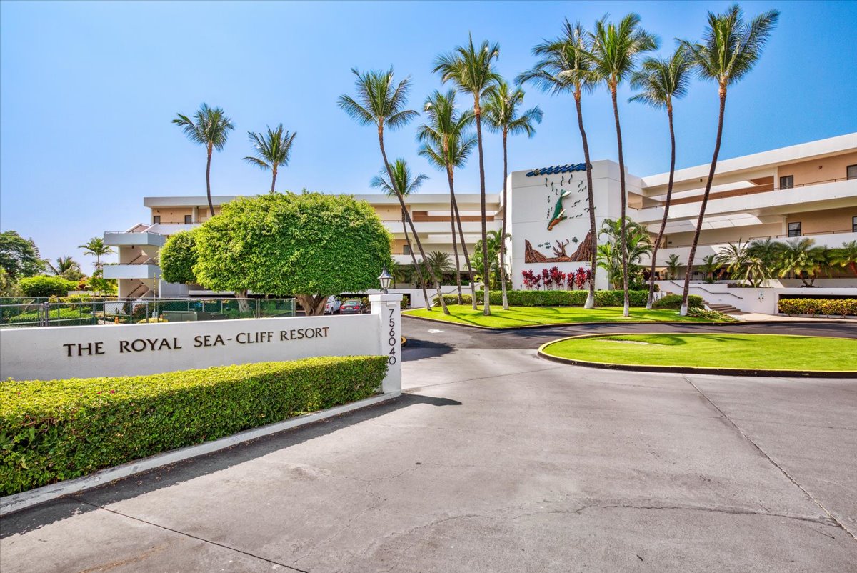 75-6040 Alii Drive, Unit 303 Kailua-Kona, HI 96740 - Photo 2 of 24 a view of swimming pool with a yard and palm trees