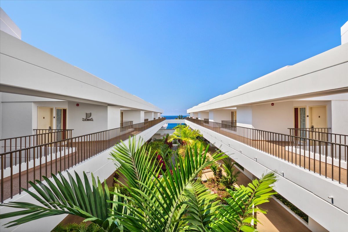 75-6040 Alii Drive, Unit 303 Kailua-Kona, HI 96740 - Photo 21 of 24 a view of a swimming pool with a flower garden