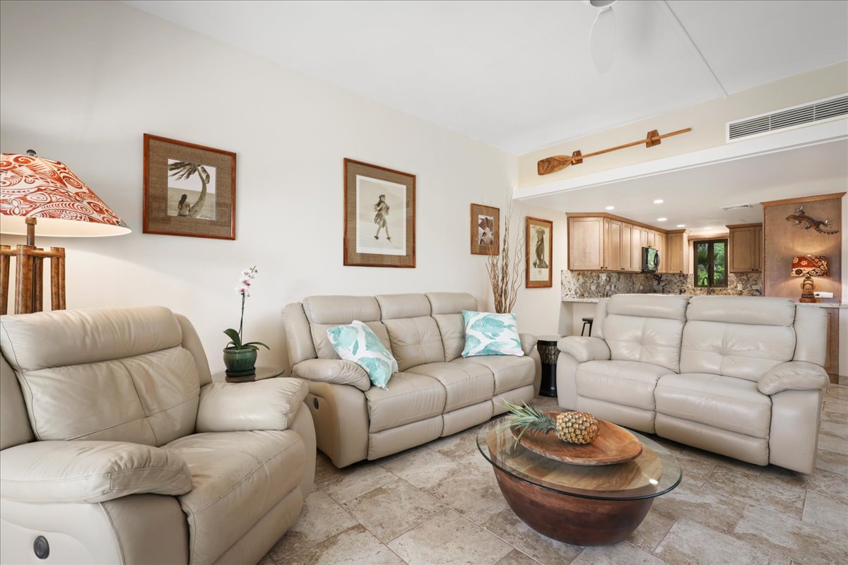 75-6040 Alii Drive, Unit 303 Kailua-Kona, HI 96740 - Photo 7 of 24 a living room with furniture and a view of kitchen
