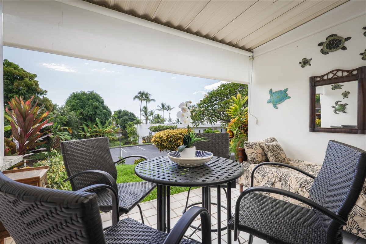 75-6040 Alii Drive, Unit 303 Kailua-Kona, HI 96740 - Photo 10 of 24 a view of a dining room with furniture and a potted plant