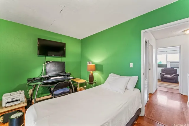 a bedroom with a bed and a flat screen tv