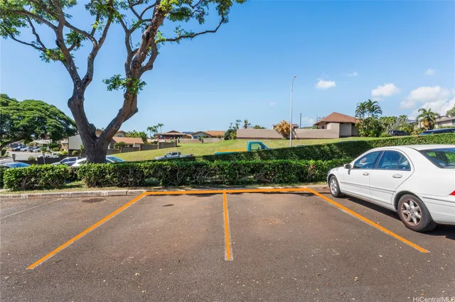 a view of a street with a car parked on the road