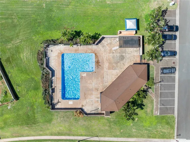 an aerial view of a house with a yard