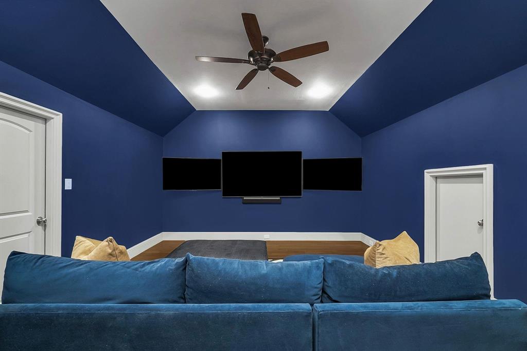 12114 Prestonridge Road Dallas, TX 75230 - Photo 35 of 40 Media room with deep blue walls and a vaulted ceiling featuring recessed lighting and a ceiling fan