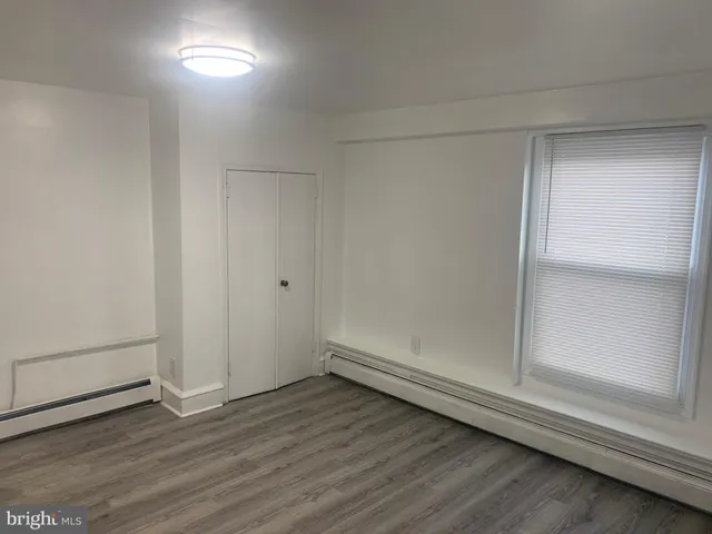 an empty room with wooden floor