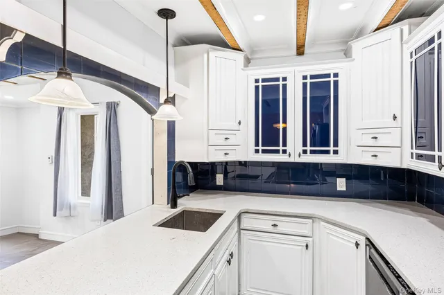 a kitchen with a sink cabinets and window