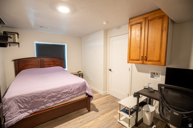 1373 South Raintree Lane Santaquin, UT 84655 - Photo 20 of 29 Bedroom with an office area, light wood-style flooring, and a textured ceiling