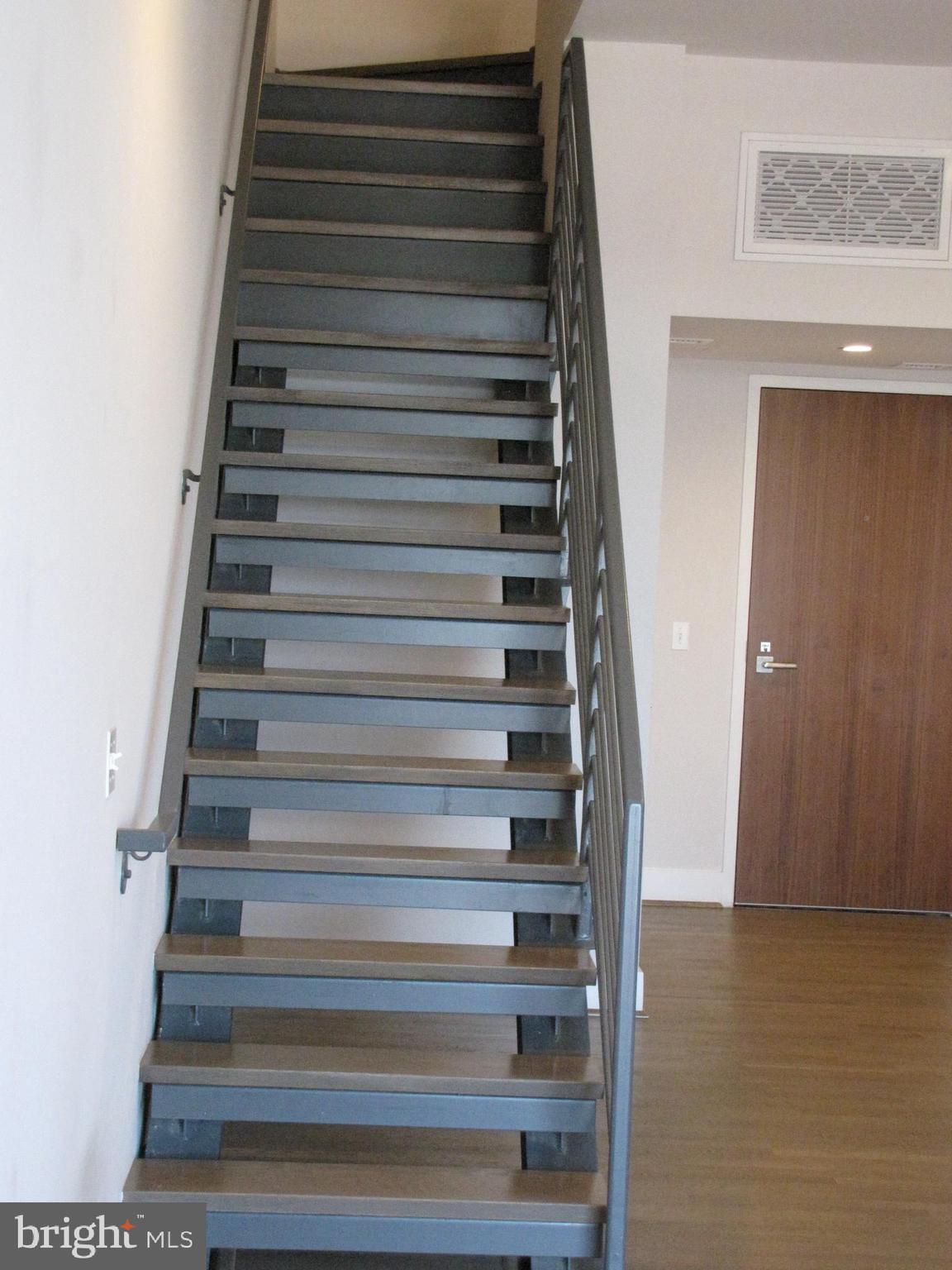 525 Water Street Southwest, Unit 404 Washington, DC 20024 - Photo 7 of 31 Open staircase to upper level living.