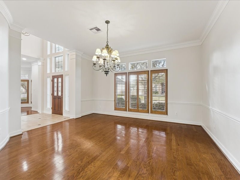 11404 Island Manor Street Pearland, TX 77584 - Photo 10 of 42 A spacious dining room with hardwood floors flows seamlessly into the updated kitchen.