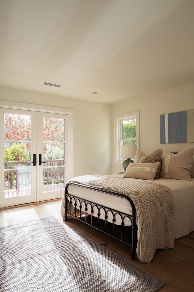 1221 Foothill Road Ojai, CA 93023 - Photo 18 of 42 a bedroom with a large bed and a large window with outer view