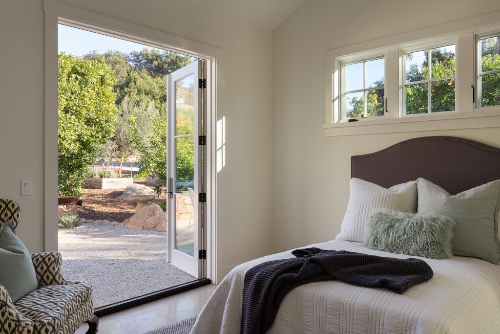 1221 Foothill Road Ojai, CA 93023 - Photo 30 of 42 a bedroom with a large bed and a large window