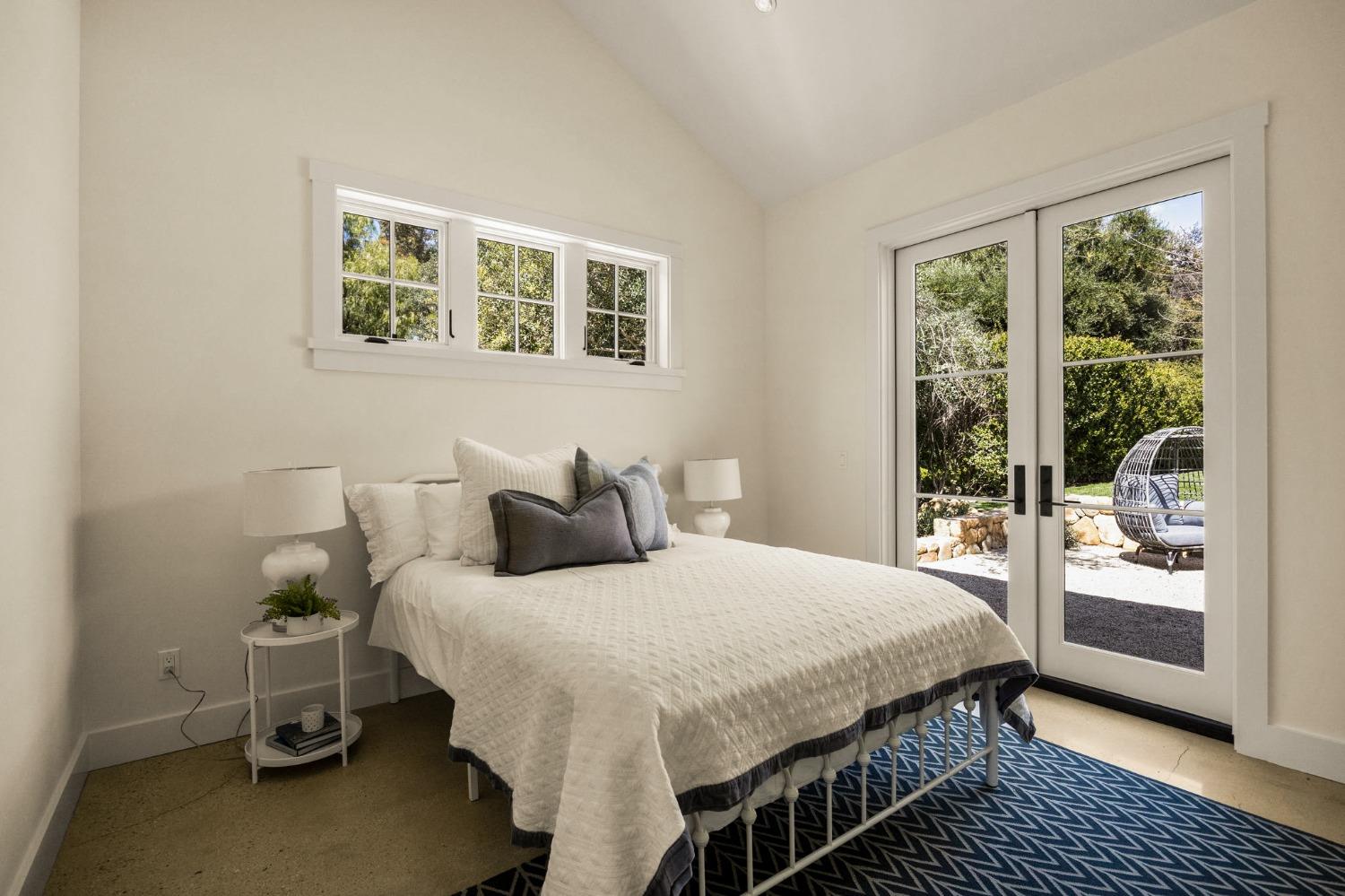 1221 Foothill Road Ojai, CA 93023 - Photo 31 of 42 a bedroom with a bed and glass door