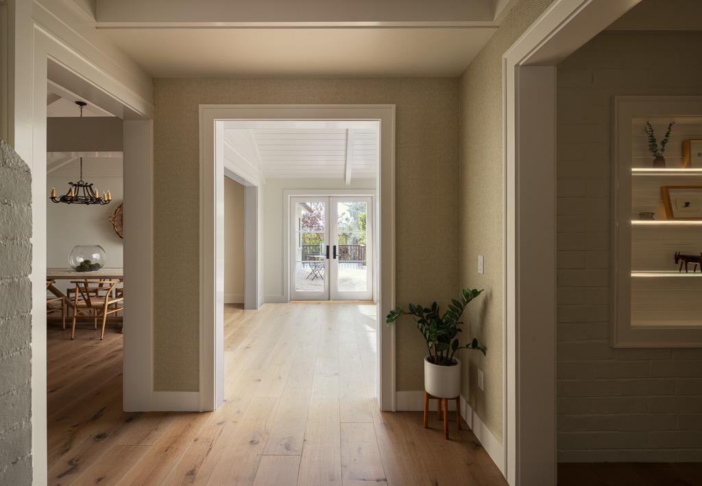 1221 Foothill Road Ojai, CA 93023 - Photo 7 of 42 a view of a hallway and a dining room with wooden floor