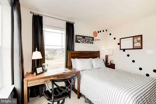 a bedroom with a large bed and a large window