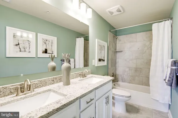 a living room with lots of furniture and view of kitchen