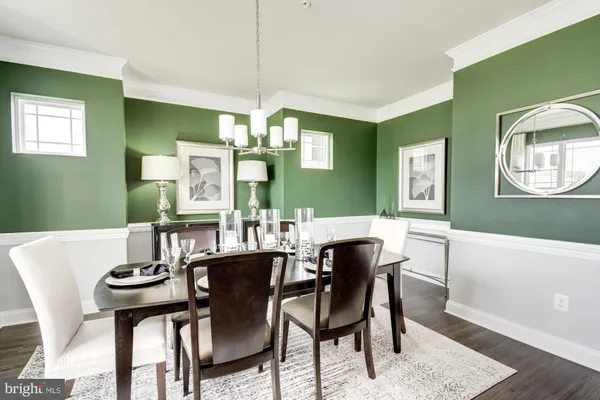 a view of a dining room with furniture and chandelier