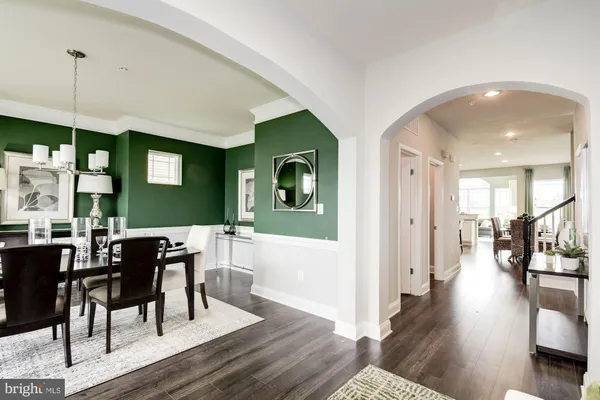 a living room with furniture and a painting on the wall