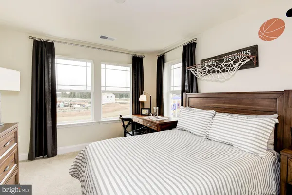 a bedroom with a large bed and a window