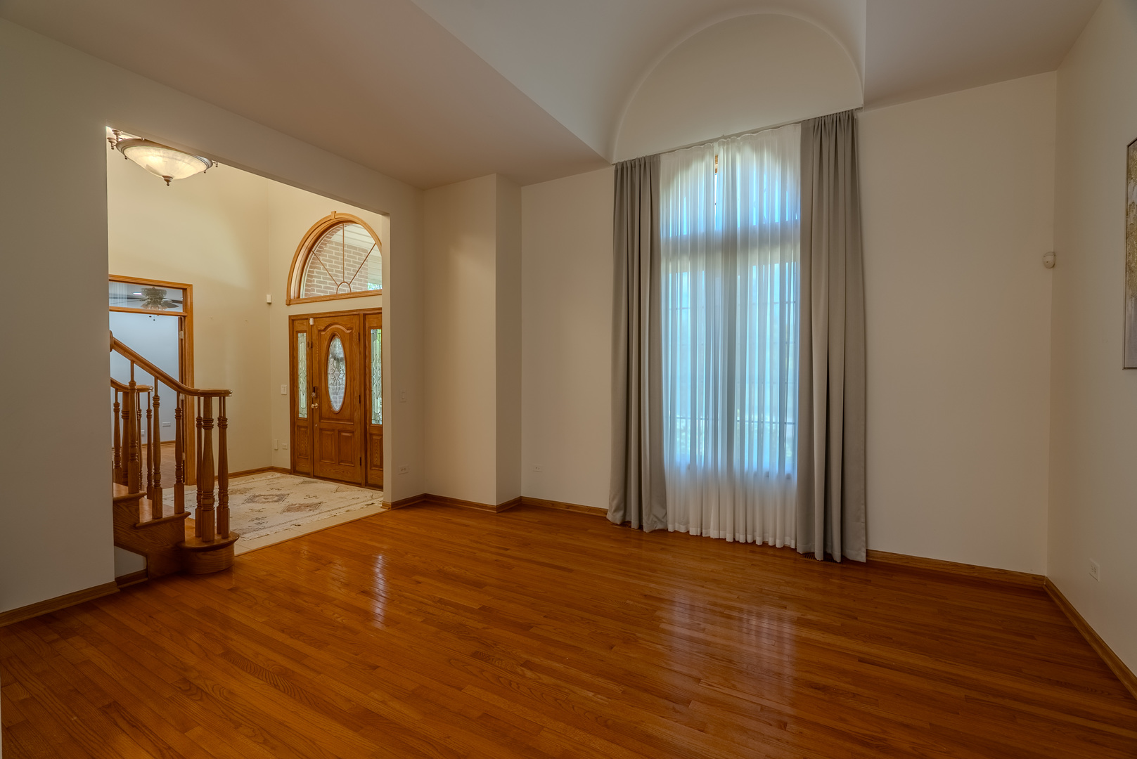 11617 Coach Drive Mokena, IL 60448 - Photo 15 of 38 an empty room with wooden floor mirror and windows