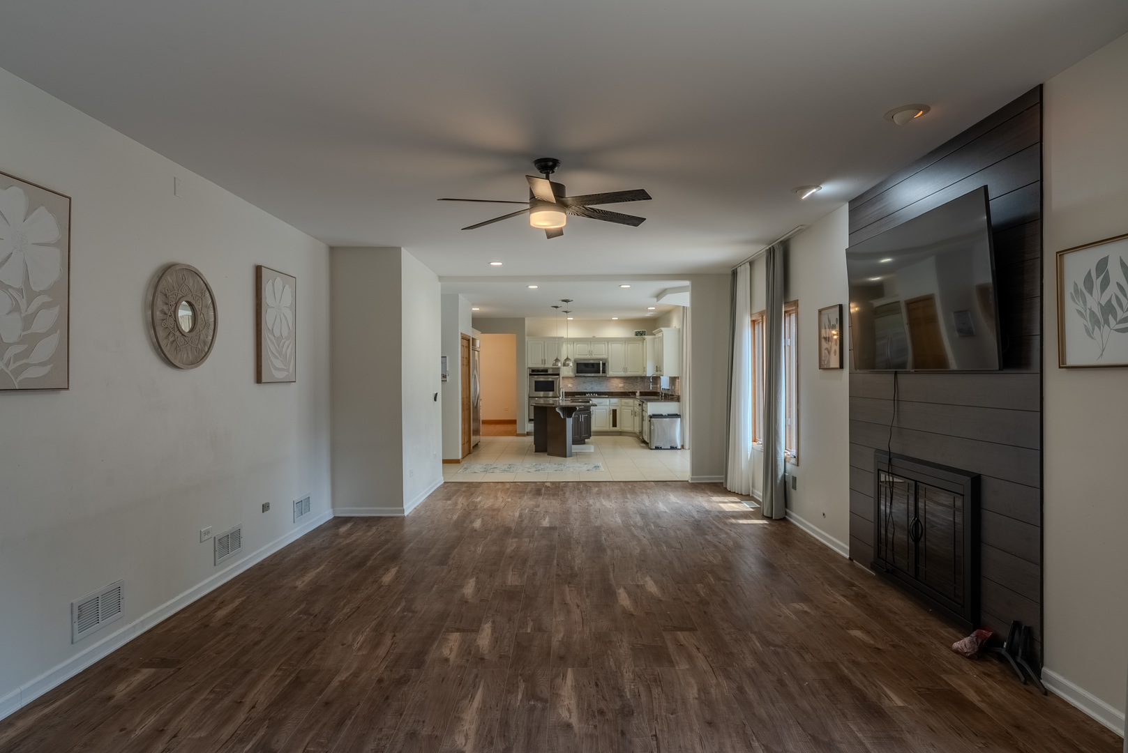 11617 Coach Drive Mokena, IL 60448 - Photo 22 of 38 a view of a kitchen with a refrigerator a ceiling fan and wooden floor