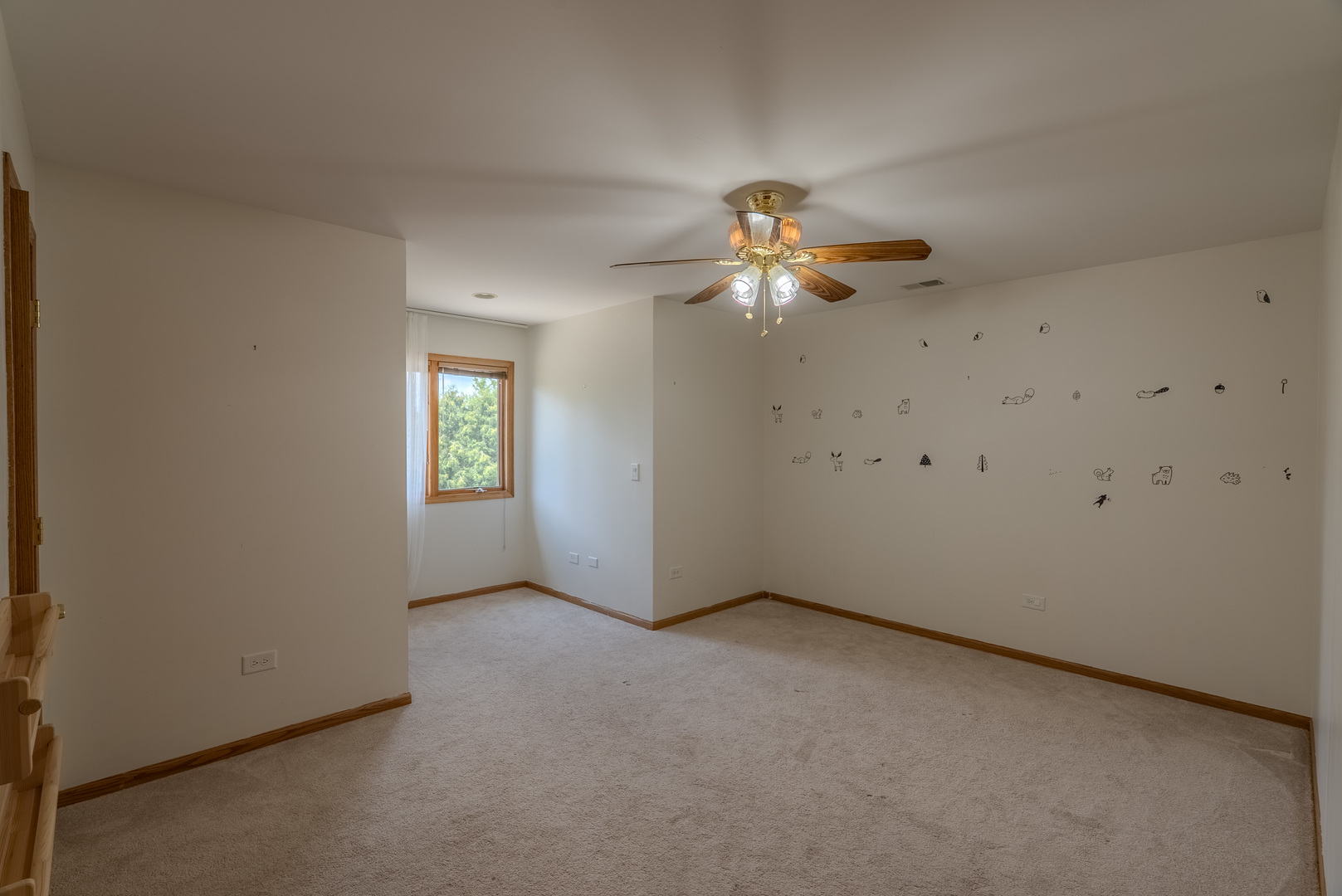 11617 Coach Drive Mokena, IL 60448 - Photo 31 of 38 an empty room with a chandelier fan and windows