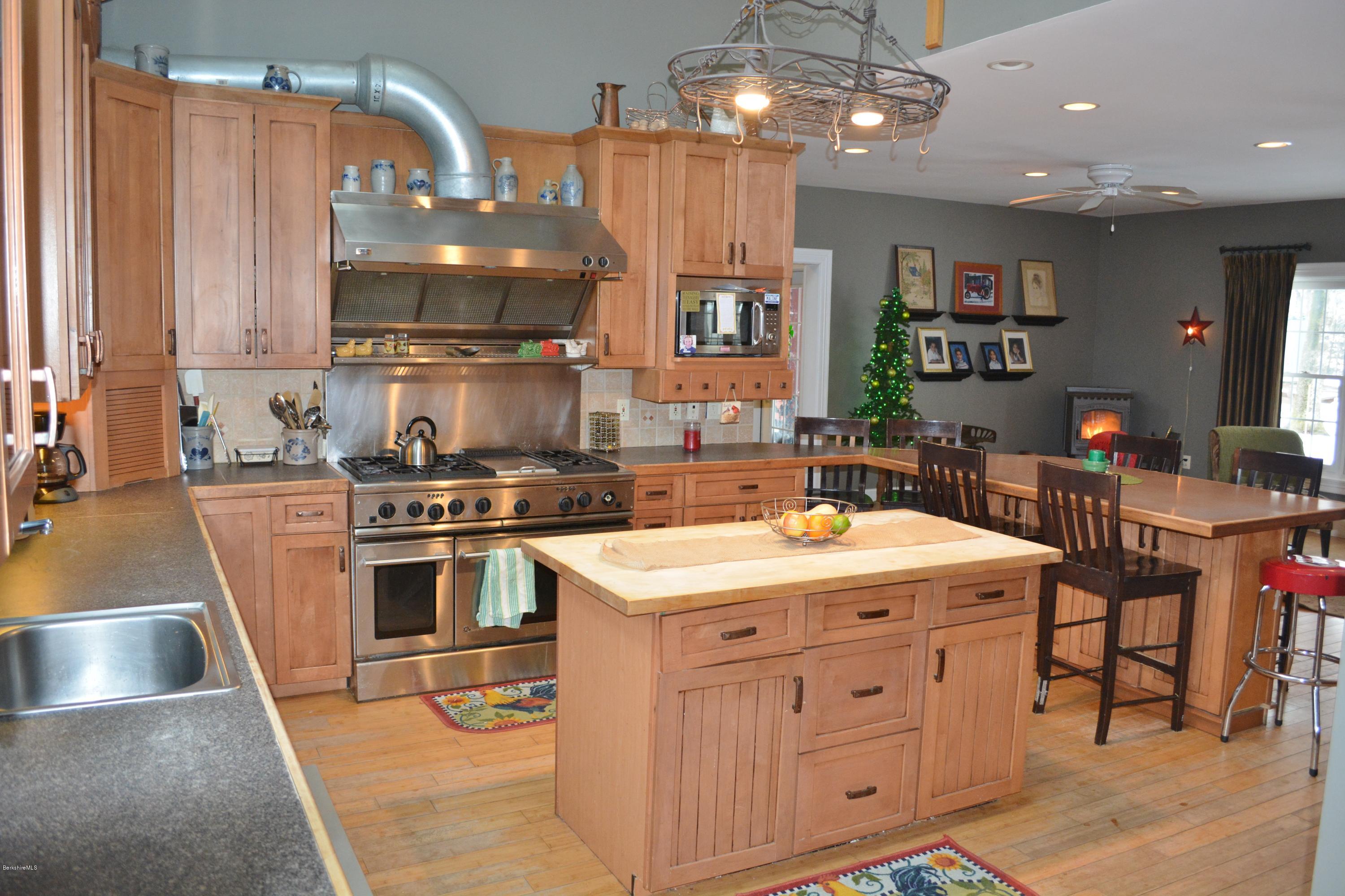 27 Kibbe Point Road Otis, MA 01029 - Photo 12 of 30 a kitchen with stainless steel appliances granite countertop a sink a stove and a wooden floors