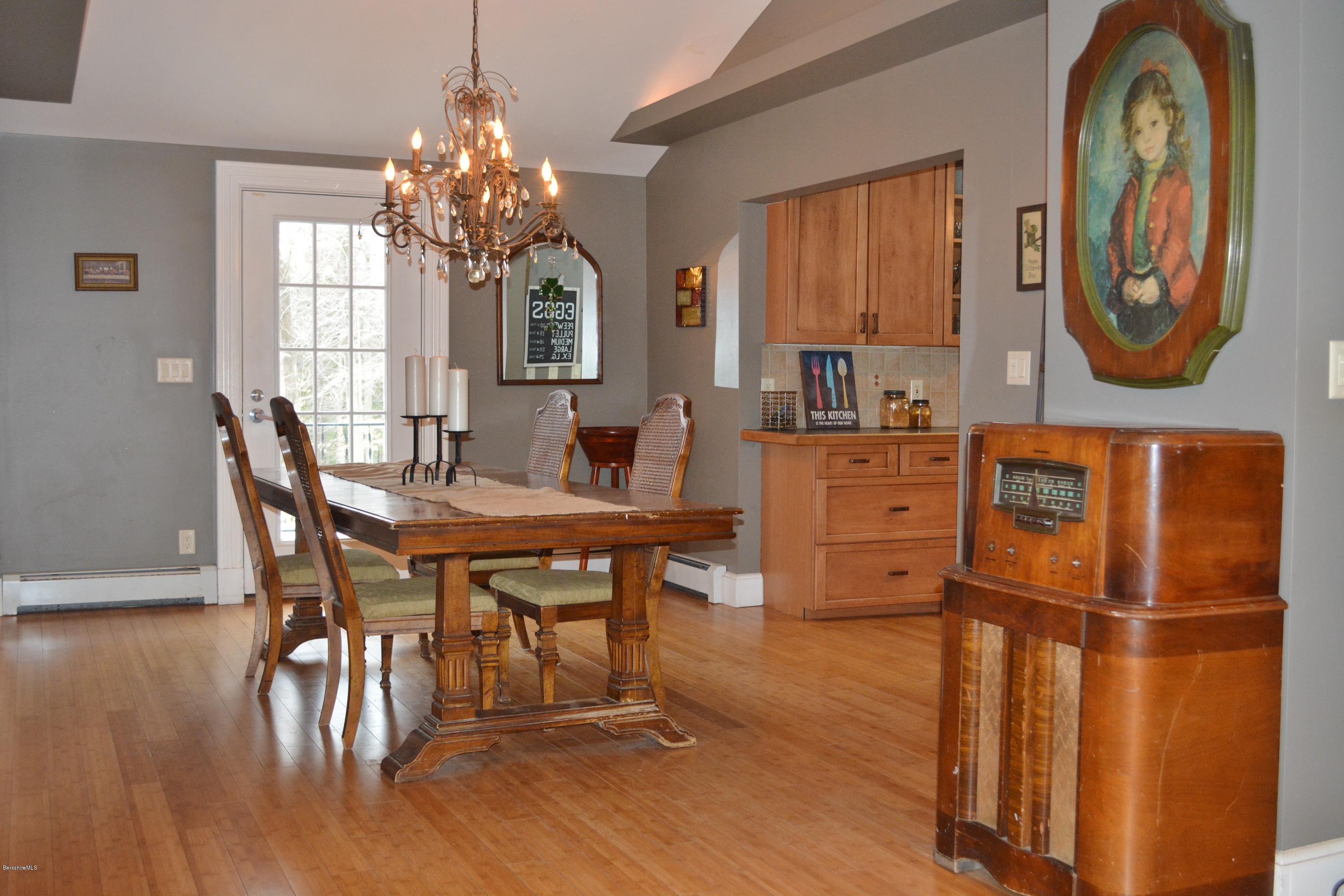 27 Kibbe Point Road Otis, MA 01029 - Photo 13 of 30 a dining room with furniture a chandelier and wooden floor