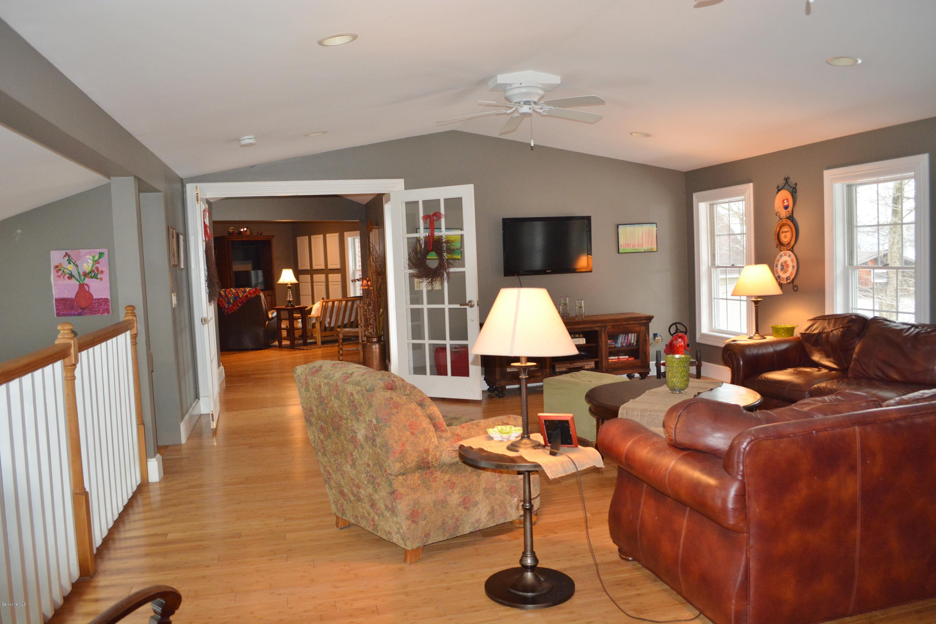27 Kibbe Point Road Otis, MA 01029 - Photo 14 of 30 a living room with furniture a flat screen tv and a large window