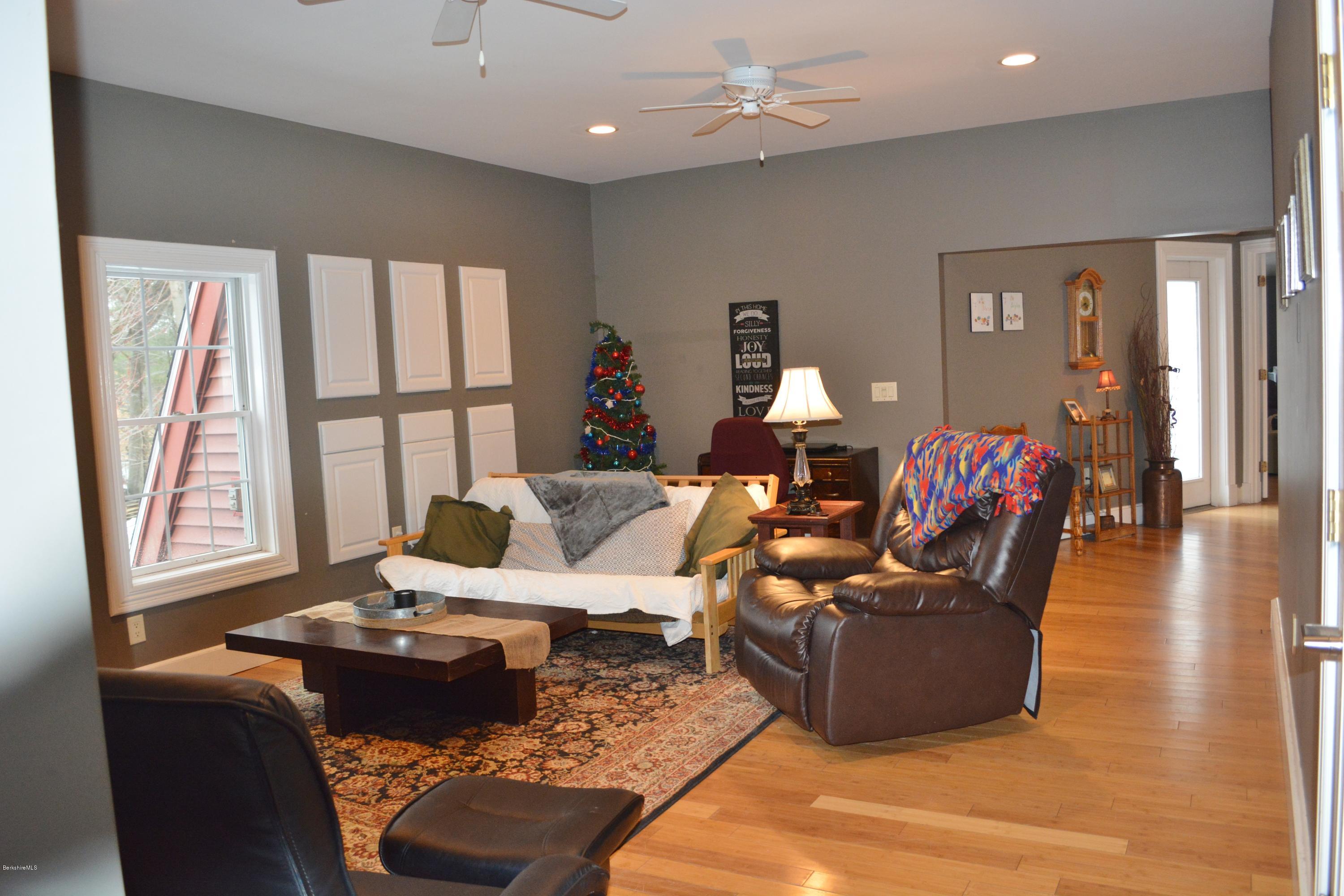 27 Kibbe Point Road Otis, MA 01029 - Photo 16 of 30 a living room with furniture fireplace and a large window