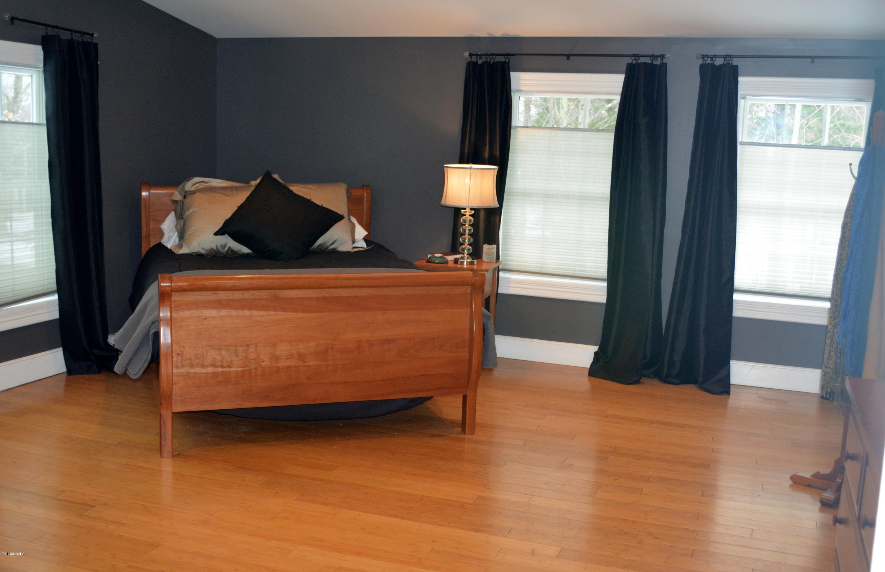 27 Kibbe Point Road Otis, MA 01029 - Photo 17 of 30 a bed sitting in a bedroom next to a window
