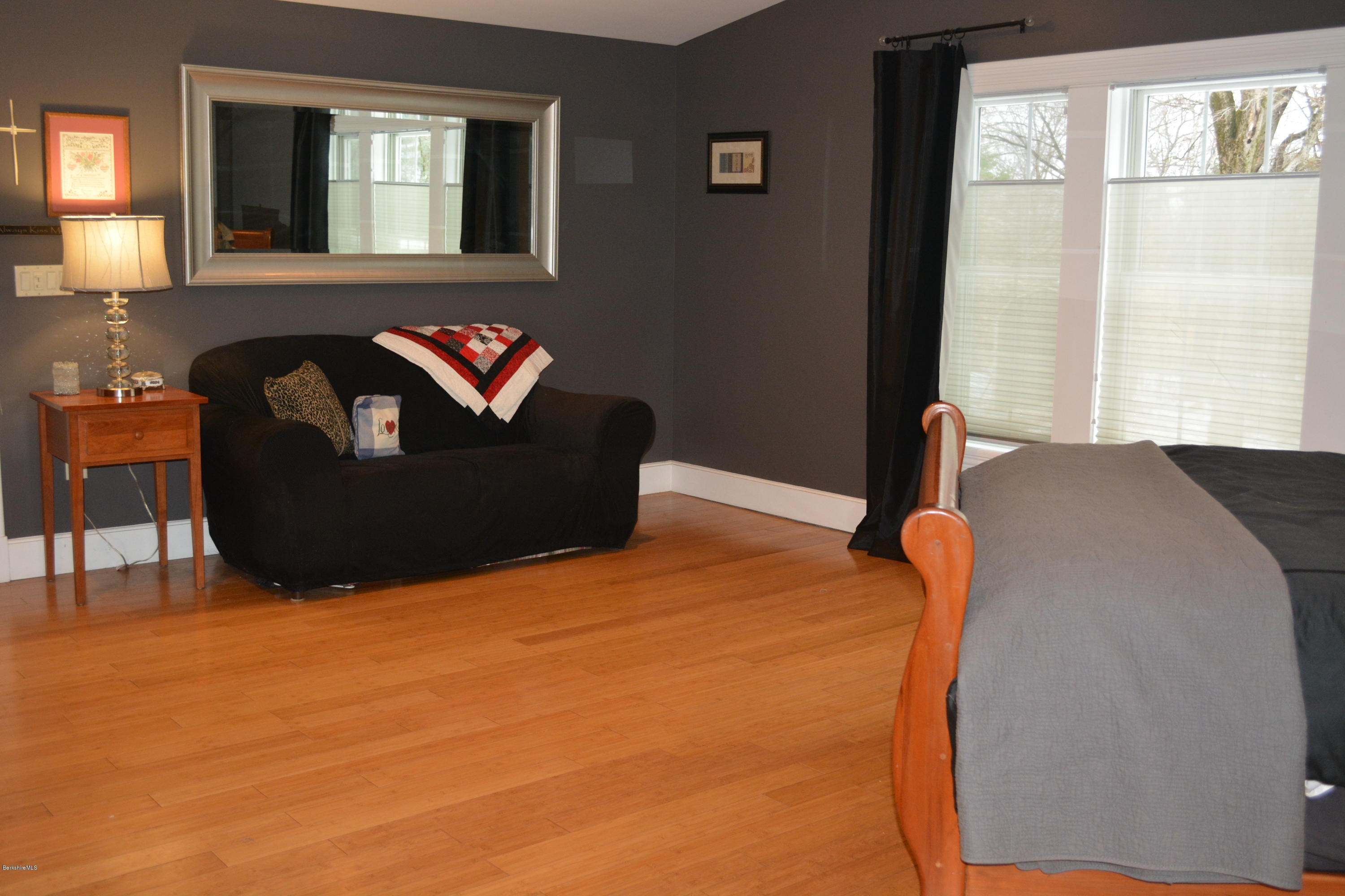 27 Kibbe Point Road Otis, MA 01029 - Photo 19 of 30 a bedroom with a bed and wooden floor