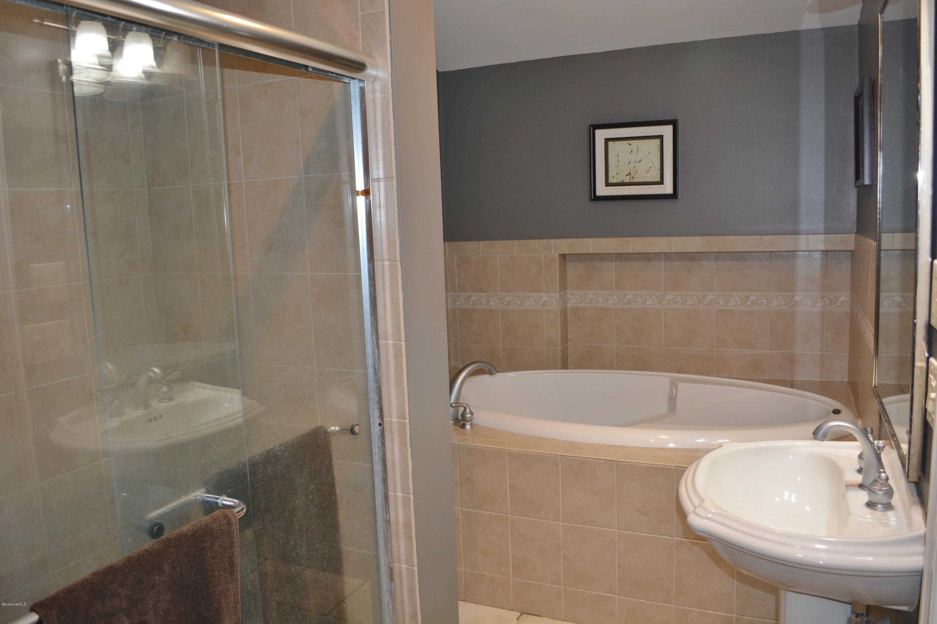 27 Kibbe Point Road Otis, MA 01029 - Photo 20 of 30 a bathroom with a sink and a mirror