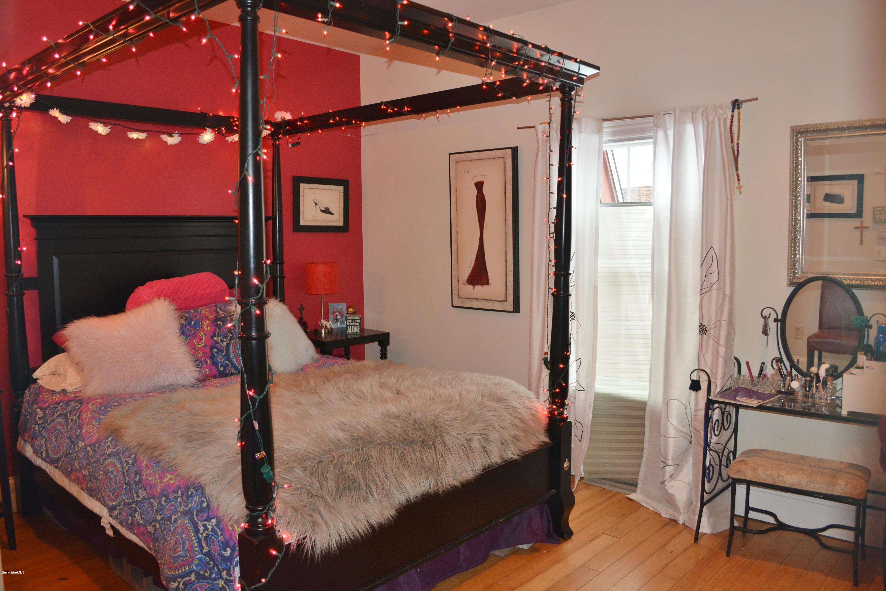 27 Kibbe Point Road Otis, MA 01029 - Photo 22 of 30 a bedroom with a bed a lamp and dresser