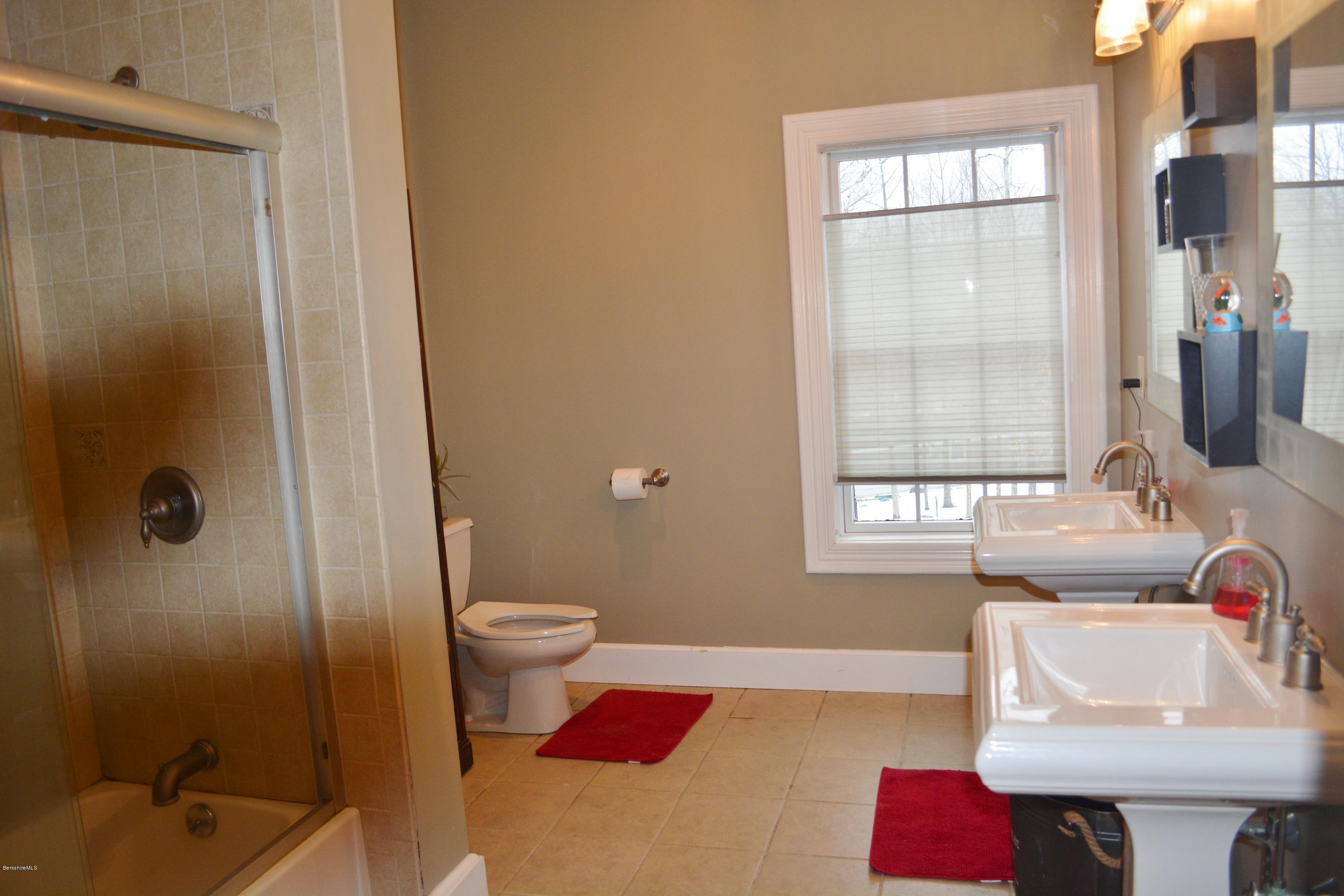 27 Kibbe Point Road Otis, MA 01029 - Photo 24 of 30 a bathroom with a sink toilet and shower