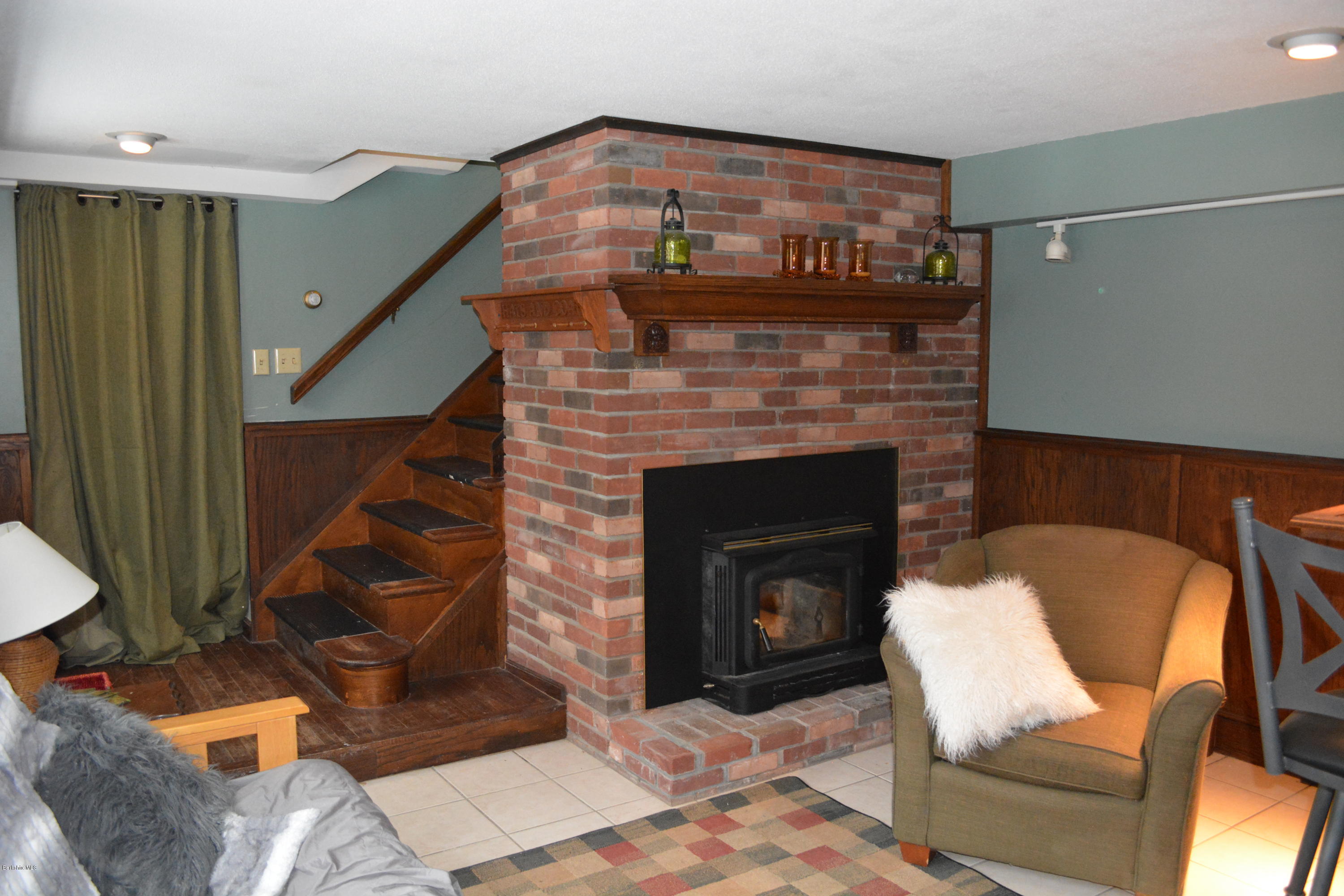 27 Kibbe Point Road Otis, MA 01029 - Photo 25 of 30 a living room with furniture and a fireplace