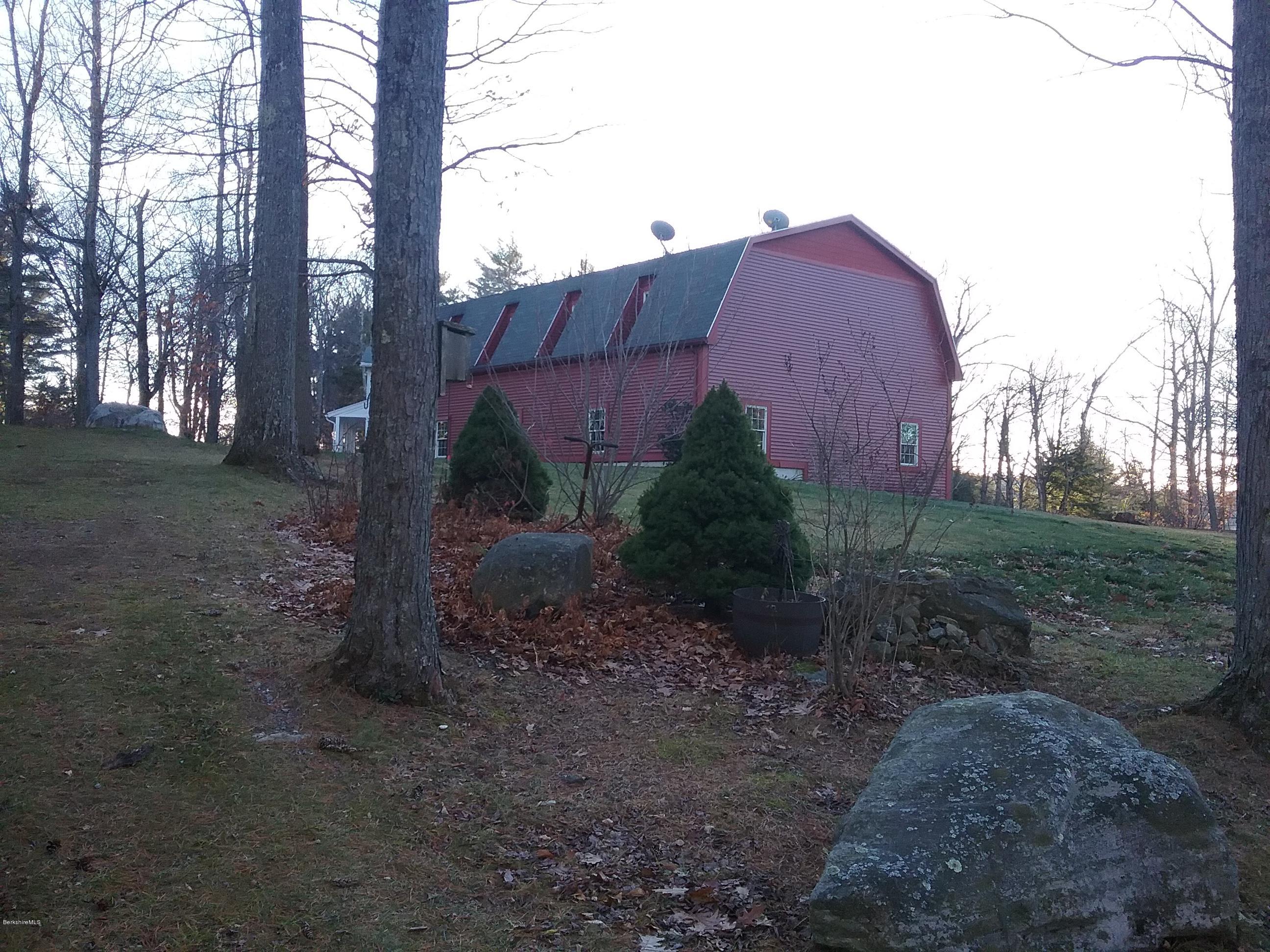 27 Kibbe Point Road Otis, MA 01029 - Photo 27 of 30 a view of a tall building with a yard