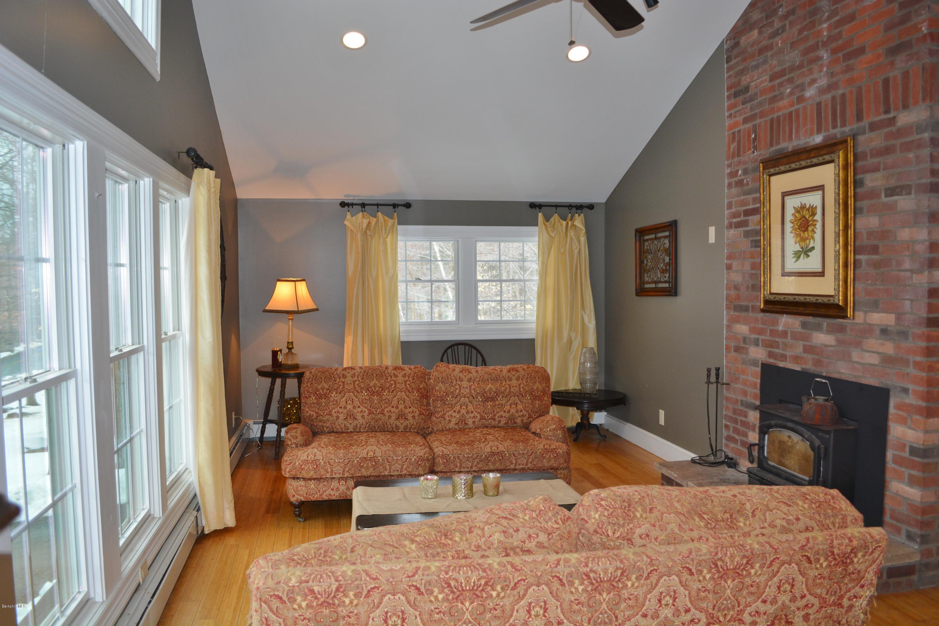27 Kibbe Point Road Otis, MA 01029 - Photo 8 of 30 a bedroom with a bed and a fireplace