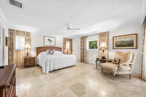 a spacious bedroom with a bed and a couch