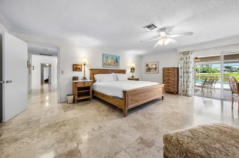 a spacious bedroom with a bed and a chandelier