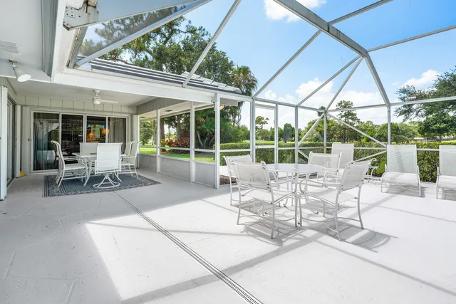 a view of a patio with table and chairs and potted plants
