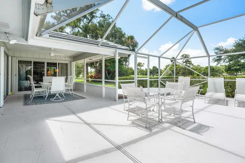 a view of a patio with table and chairs and potted plants