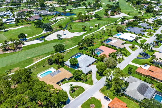 an aerial view of residential houses with outdoor space and street view