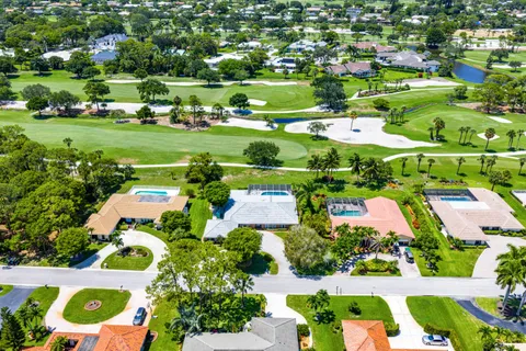 an aerial view of residential houses with yard and lake view