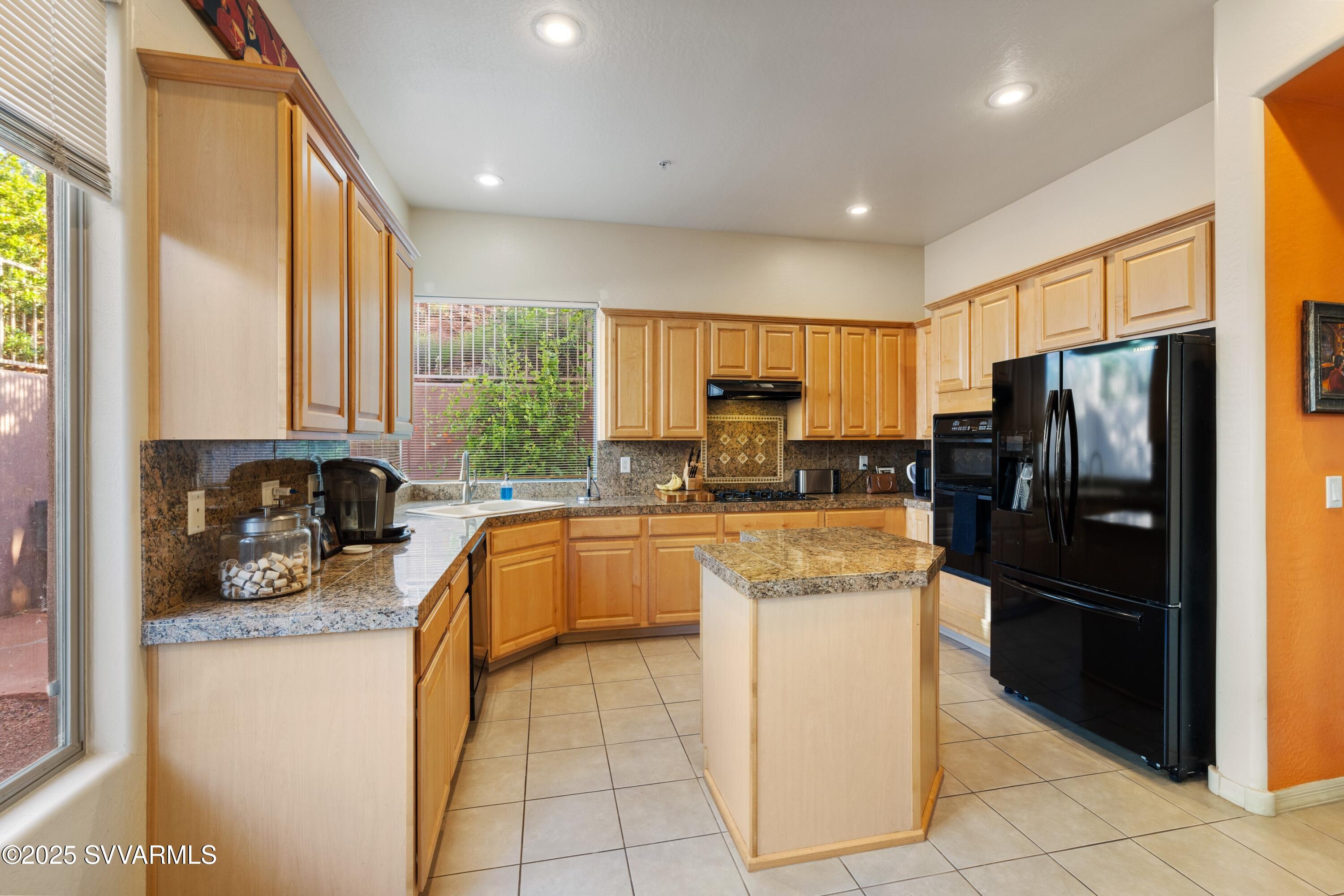 35 Rio Sinagua Sedona, AZ 86351 - Photo 14 of 67 a kitchen with a refrigerator a sink dishwasher stove top oven and cabinets