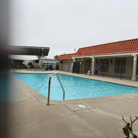 a view of building with cars parked
